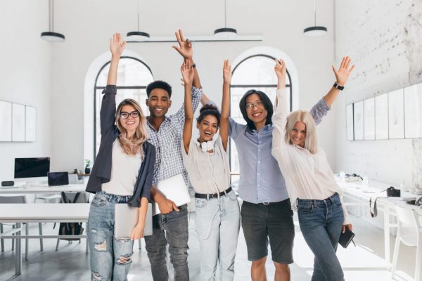 international-tired-students-celebrating-end-exams-laughing-lecture-hall-happy-freelance-programmers-done-with-long-project-posing-with-smile-holding-laptops-scaled-1536×1024